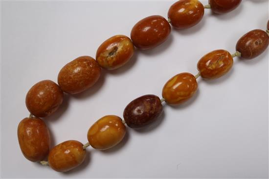 A single strand graduated oval amber bead necklace, with loose beads, gross weight 38 grams, 48cm.